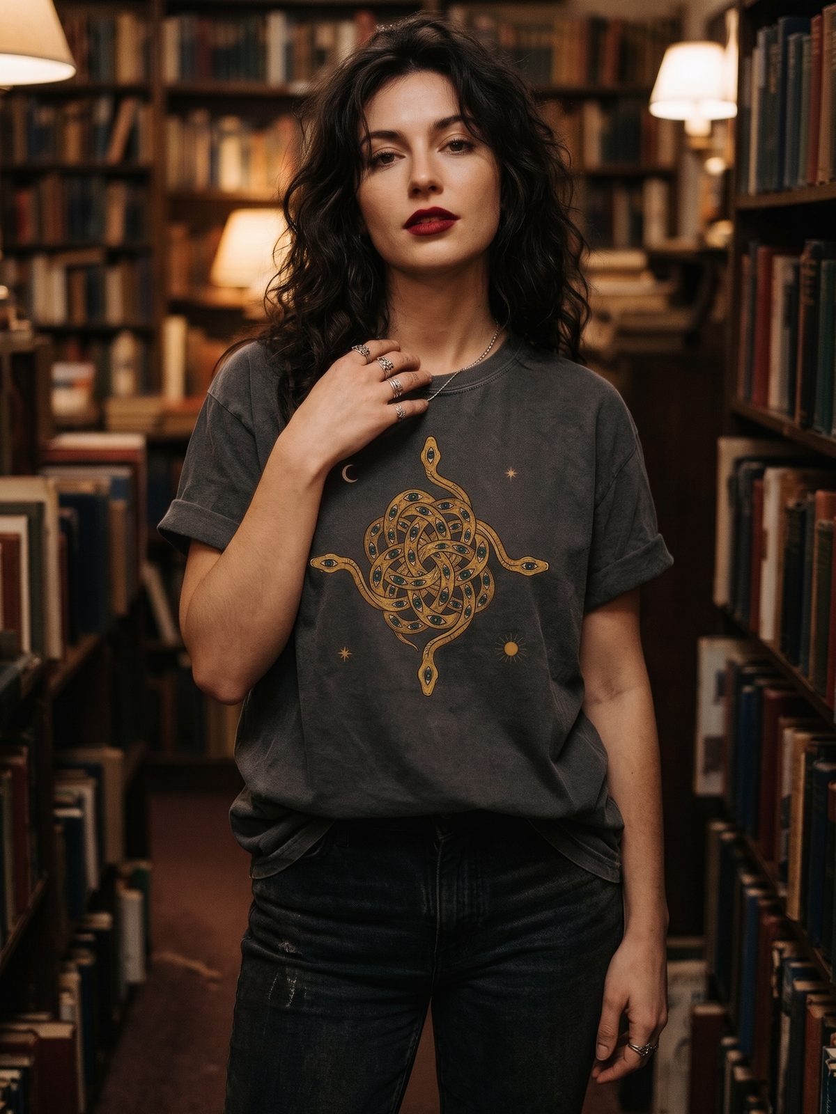 Woman in a bookshop wearing the Mystical Intertwined Serpents tee